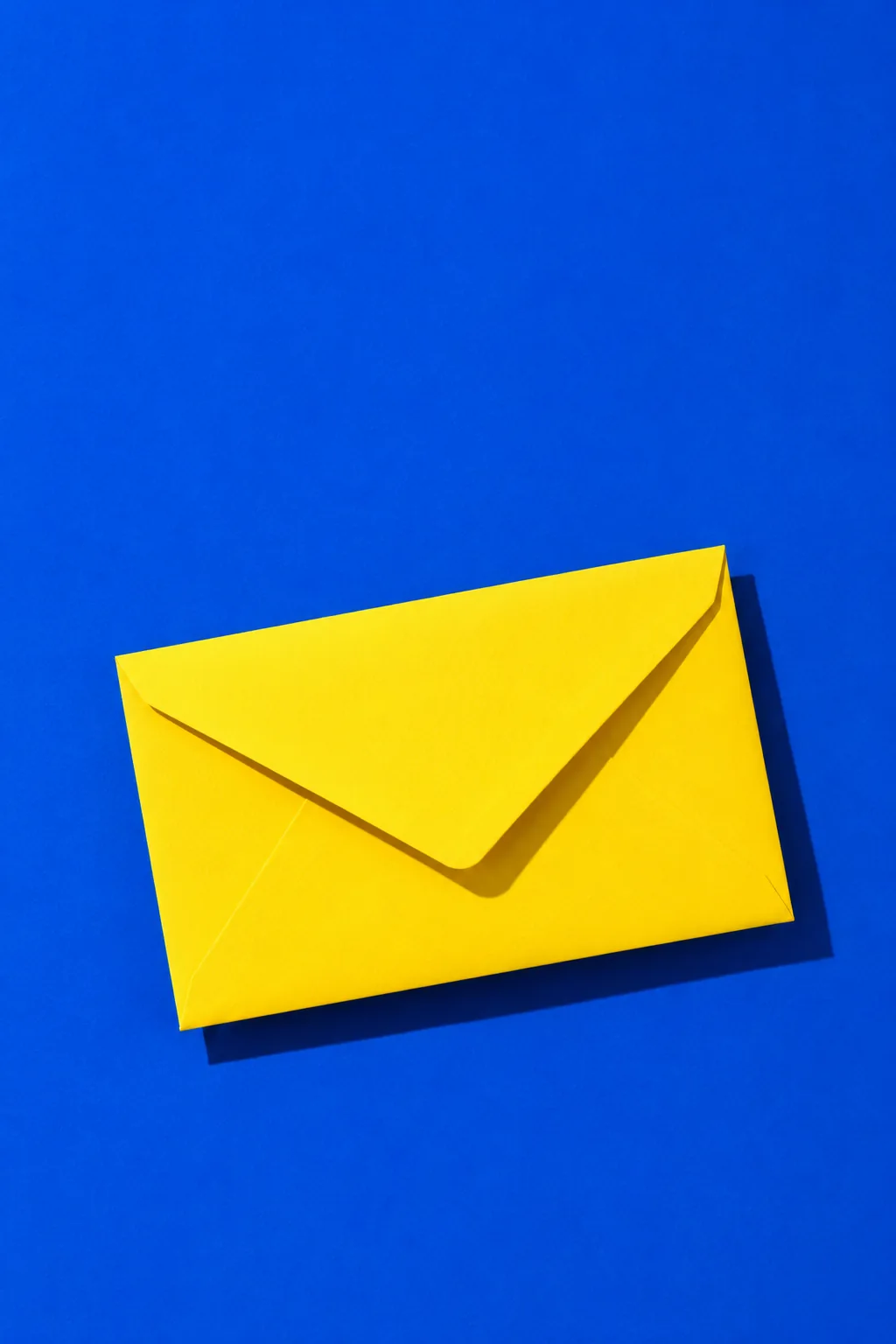 A yellow envelope on a cobalt blue background